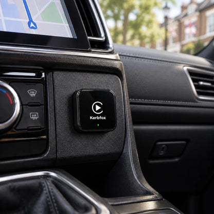 Kerbfox DashLink plugged into the car's centre console below the climate controls, with maps on the screen
